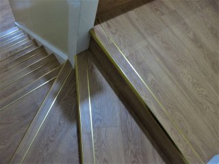 Vusta LVT (colour French Oak) fitted to a staircase with Brass Nosings Vusta LVT and nosings